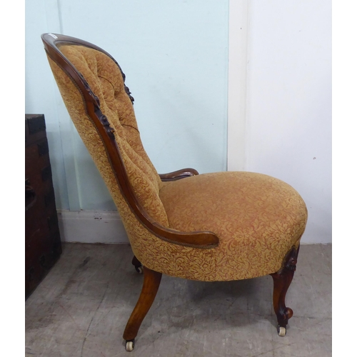 232 - A late Victorian walnut showwood framed nursing chair, part-button upholstered in floral patterned f... 