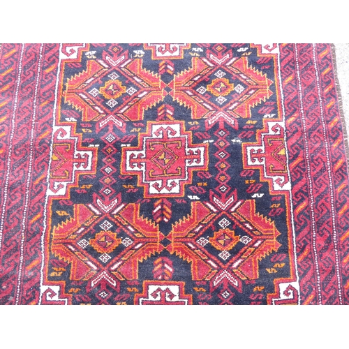 244 - A Persian rug, on a red ground  41