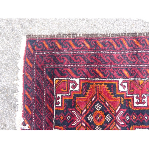 244 - A Persian rug, on a red ground  41