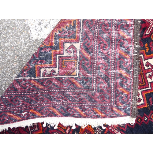 244 - A Persian rug, on a red ground  41