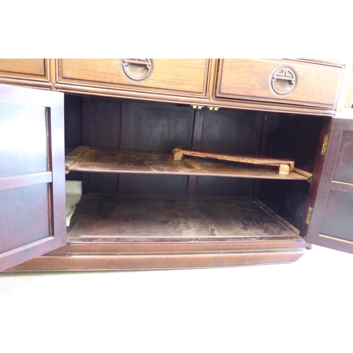 245 - A 20thC Chinese fruitwood dresser with four in-line drawers, over four panelled doors, raised on sha... 