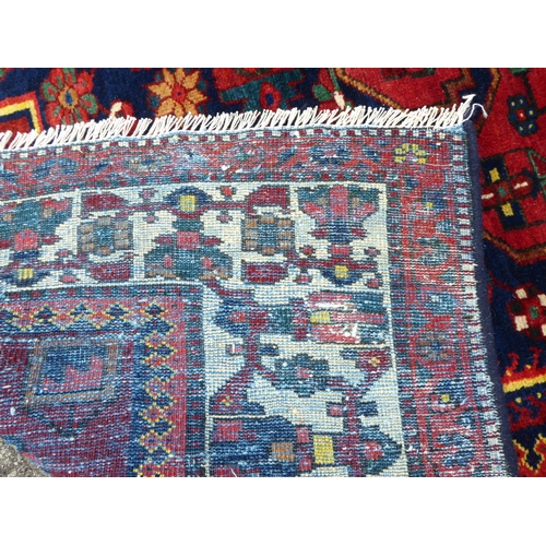 246 - A Persian carpet, decorated with mirrored decoration, on a multi-coloured ground  84