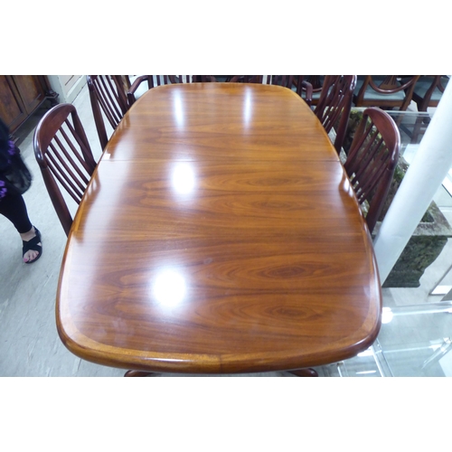 247 - A Skovby mahogany dining table, the oval top on an elongated X-shape underframe  29