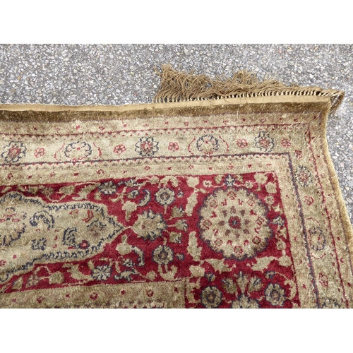 248 - A Persian partial silk woven rug, on a cream coloured ground  72