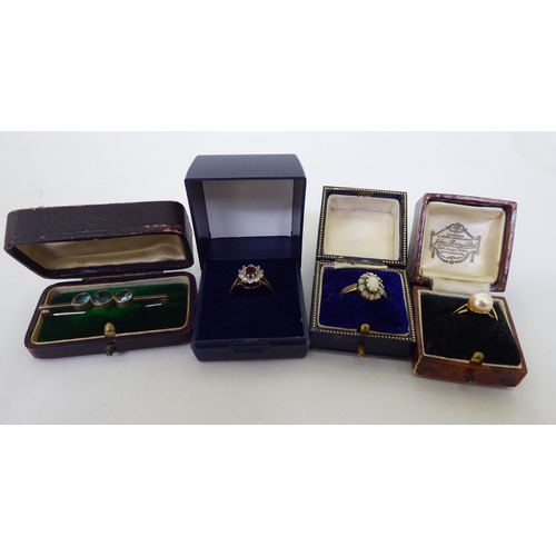 252 - Three yellow metal rings: to include one set with a pearl  stamped 18ct; and a three coloured s... 