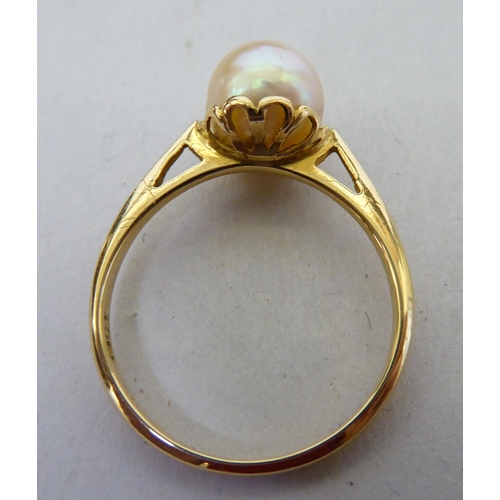 252 - Three yellow metal rings: to include one set with a pearl  stamped 18ct; and a three coloured s... 