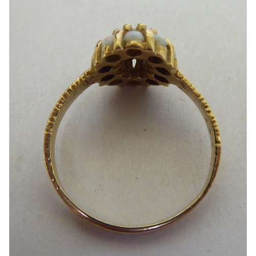 252 - Three yellow metal rings: to include one set with a pearl  stamped 18ct; and a three coloured s... 