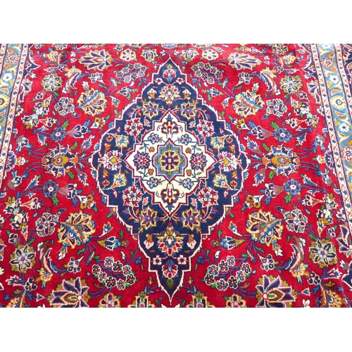 260 - An Iranian carpet, profusely decorated with repeating stylised designs, on a multi-coloured ground&n... 