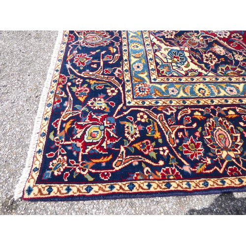 260 - An Iranian carpet, profusely decorated with repeating stylised designs, on a multi-coloured ground&n... 