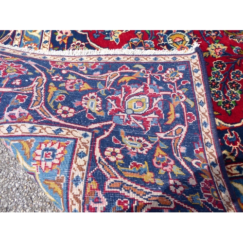 260 - An Iranian carpet, profusely decorated with repeating stylised designs, on a multi-coloured ground&n... 