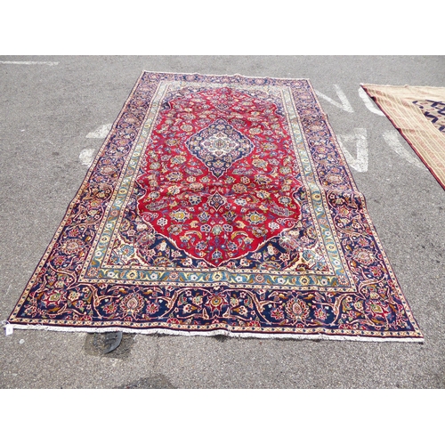 260 - An Iranian carpet, profusely decorated with repeating stylised designs, on a multi-coloured ground&n... 