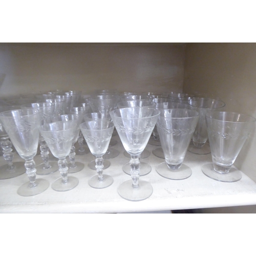 281 - A suite of glassware with foliage decorative banding: to include pedestal wines