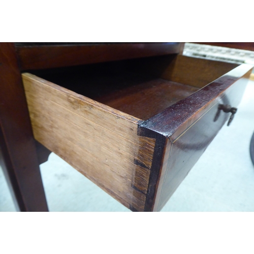 290 - An Edwardian mahogany pot cupboard with a low gallery, over a door and drawer, raised on square legs... 