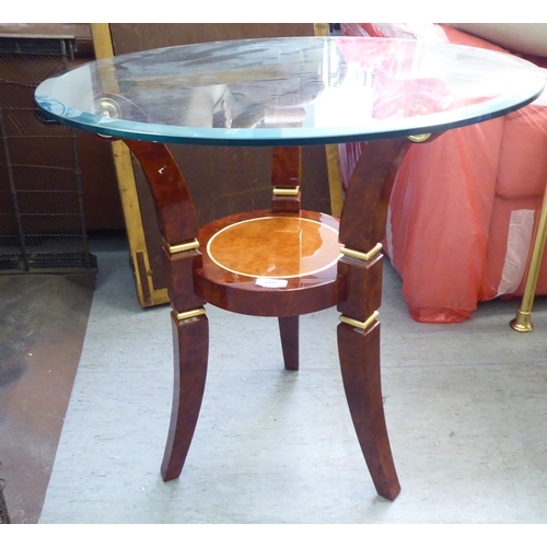 308 - A modern walnut finished occasional table with a glass top, raised on splayed legs  24