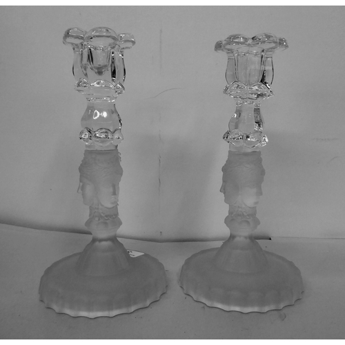 309 - MMA - a pair of clear and partially frosted glass candlesticks, decorated with mask ornament  8