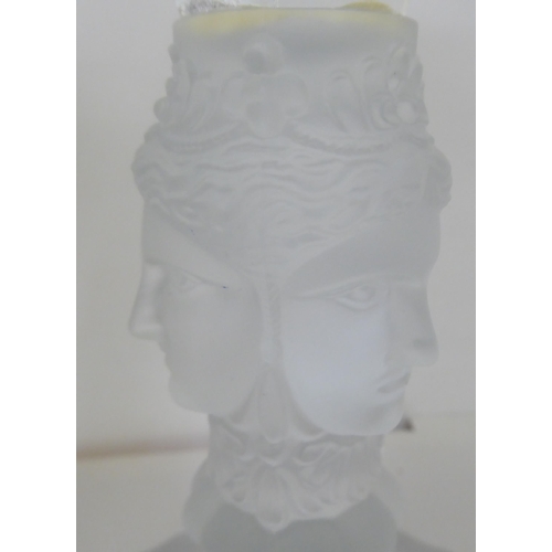 309 - MMA - a pair of clear and partially frosted glass candlesticks, decorated with mask ornament  8