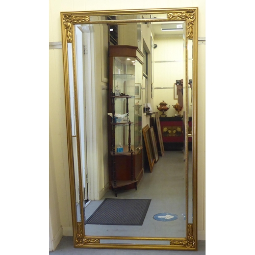 312 - A modern mirror with a multi-panelled, bevelled plate, in a gilt frame  74