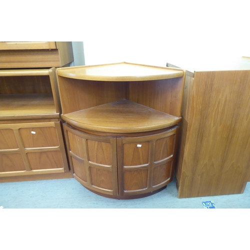 315 - A suite of modern teak living room furniture: to include two tall units with an arrangement of open ... 