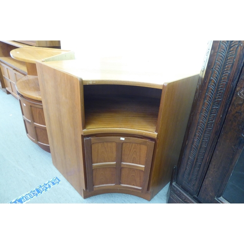 315 - A suite of modern teak living room furniture: to include two tall units with an arrangement of open ... 