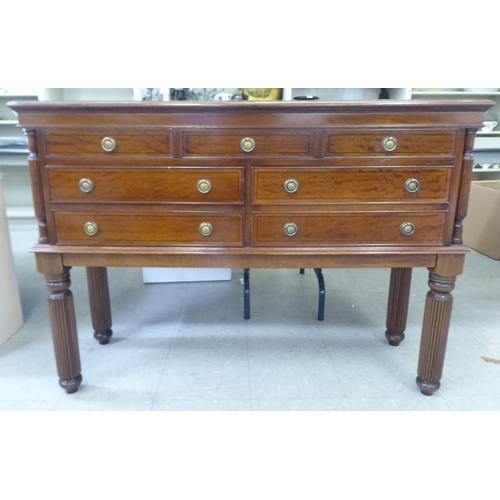 317 - A modern mahogany finished canteen cabinet containing Kings pattern cutlery and flatware, raised on ... 