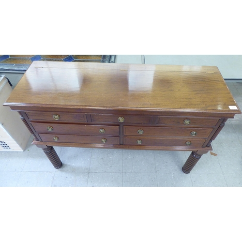 317 - A modern mahogany finished canteen cabinet containing Kings pattern cutlery and flatware, raised on ... 