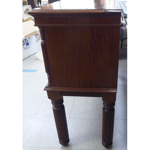 317 - A modern mahogany finished canteen cabinet containing Kings pattern cutlery and flatware, raised on ... 