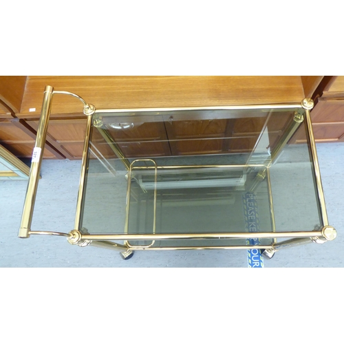 327 - A modern lacquered brass two tier tea trolley, on casters  30