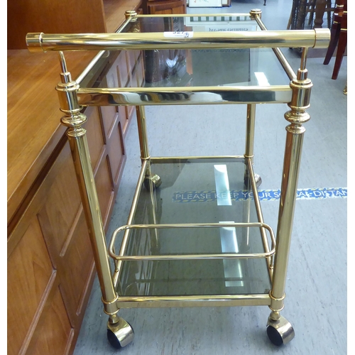 327 - A modern lacquered brass two tier tea trolley, on casters  30