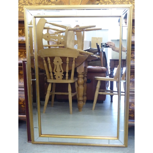 330 - A modern mirror with a multi-section bevelled plate, in a gilt frame  38