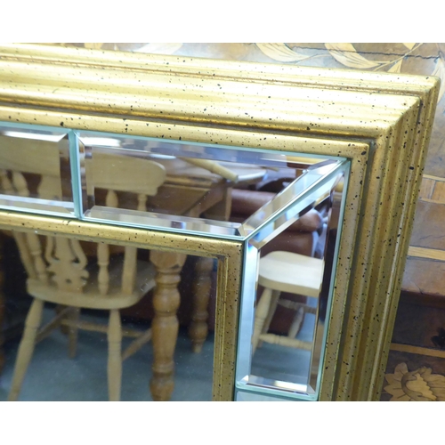 330 - A modern mirror with a multi-section bevelled plate, in a gilt frame  38