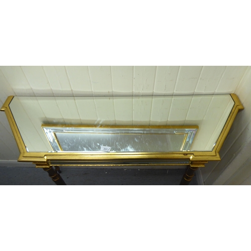 331 - A modern gilded console table with a mirrored top, raised on turned, tapered legs; and a matching mi... 