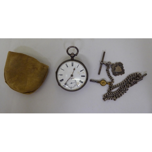 34 - A late Victorian silver cased pocket watch, faced by a white enamel Roman dial, on a silver curb lin... 