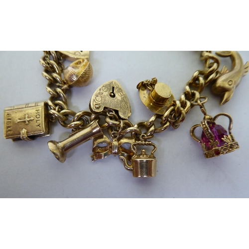 39 - A 9ct gold curb link charm bracelet, on a padlock clasp