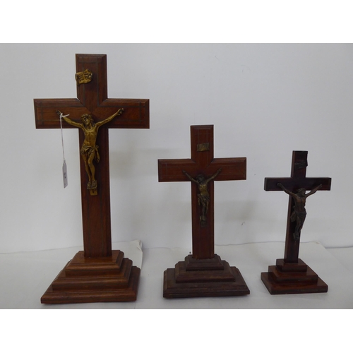 52 - Five similar crucifixes with cast metal Corpus Christi, on wooden stands  largest 16