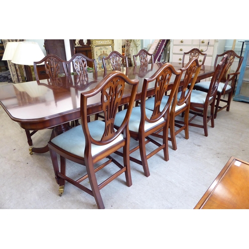 53 - A Re-Furn Heldense Regency style mahogany finished dining table, raised on twin, splayed tripod pede... 