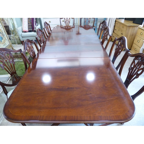 53 - A Re-Furn Heldense Regency style mahogany finished dining table, raised on twin, splayed tripod pede... 