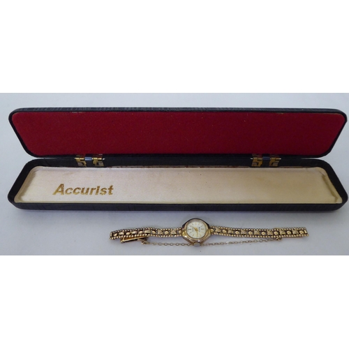 54 - A lady's Accurist 9ct gold cased, fancy link bracelet wristwatch, faced by a baton dial  cased