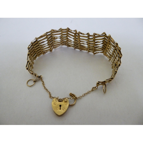 57 - A 9ct gold, wide, flexible link bracelet, on a padlock clasp