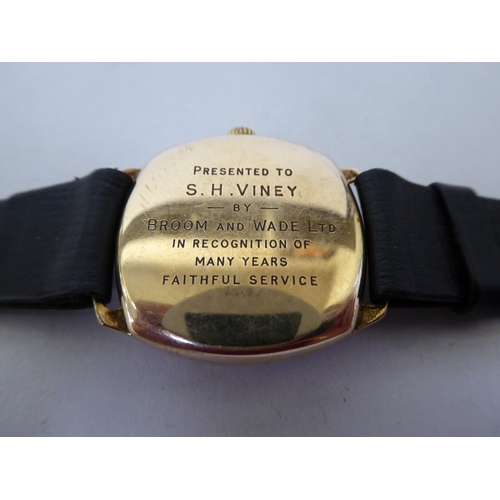 59 - A JW Benson 9ct gold cased wristwatch, faced by an Arabic dial with subsidiary seconds, on a black h... 