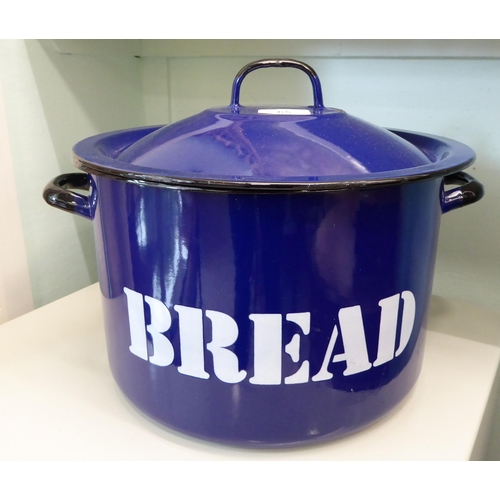 65 - A navy blue and white steel enamel twin handled bread crock with a lid  12