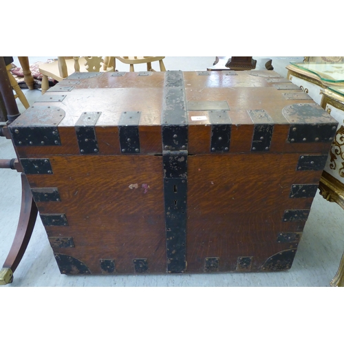 66 - A late Victorian Army & Navy oak silver chest with wrought metal strapwork and a hinged lid, enc... 