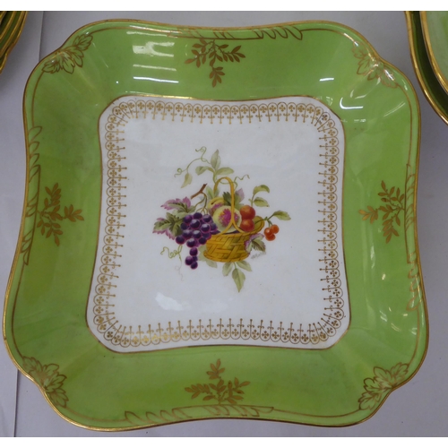 95 - An early 20thC Wedgwood china fruit service, decorated with fruit within a green banded border