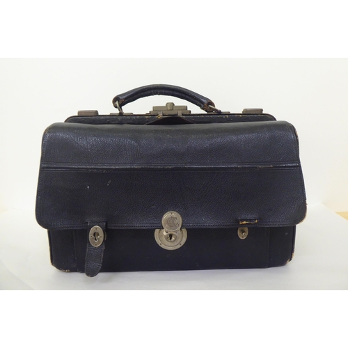 258 - An Edwardian Gladstone style vanity case, containing some silver topped receptacles  marks rubbed