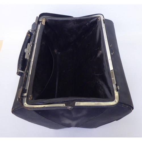 258 - An Edwardian Gladstone style vanity case, containing some silver topped receptacles  marks rubbed