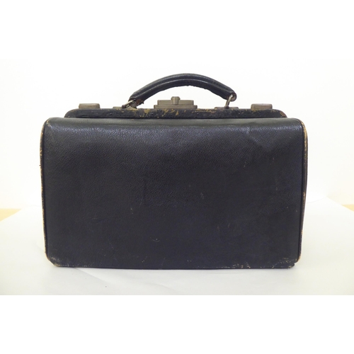 258 - An Edwardian Gladstone style vanity case, containing some silver topped receptacles  marks rubbed