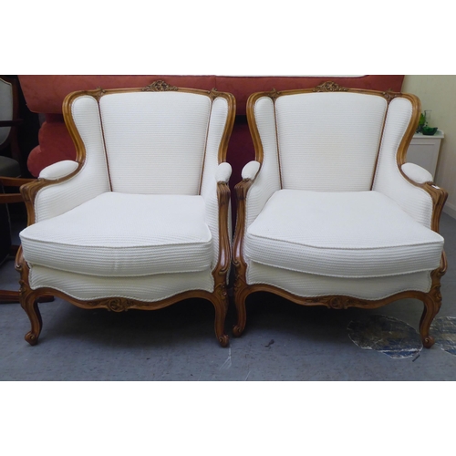 318 - A pair of mid 20thC Louis XVI design giltwood framed salon chairs, upholstered in cream coloured fab... 