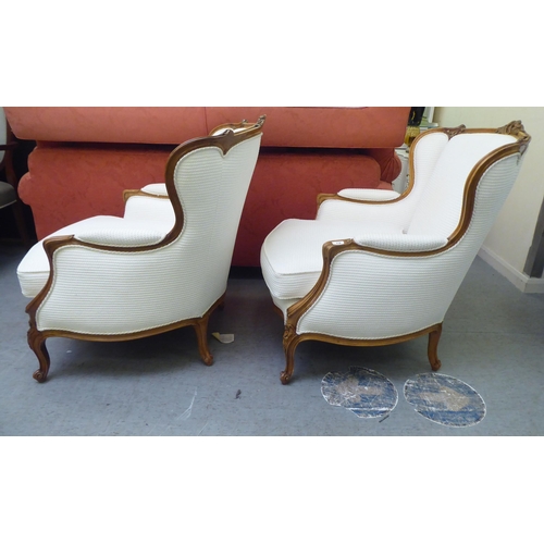 318 - A pair of mid 20thC Louis XVI design giltwood framed salon chairs, upholstered in cream coloured fab... 