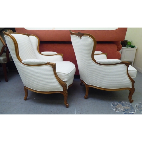 318 - A pair of mid 20thC Louis XVI design giltwood framed salon chairs, upholstered in cream coloured fab... 