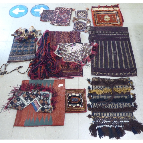 321 - Rugs, saddle bags and textiles: to include a Persian bag  32