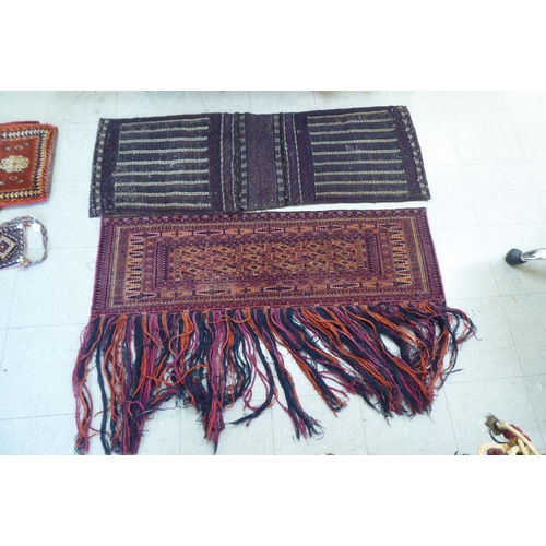 321 - Rugs, saddle bags and textiles: to include a Persian bag  32